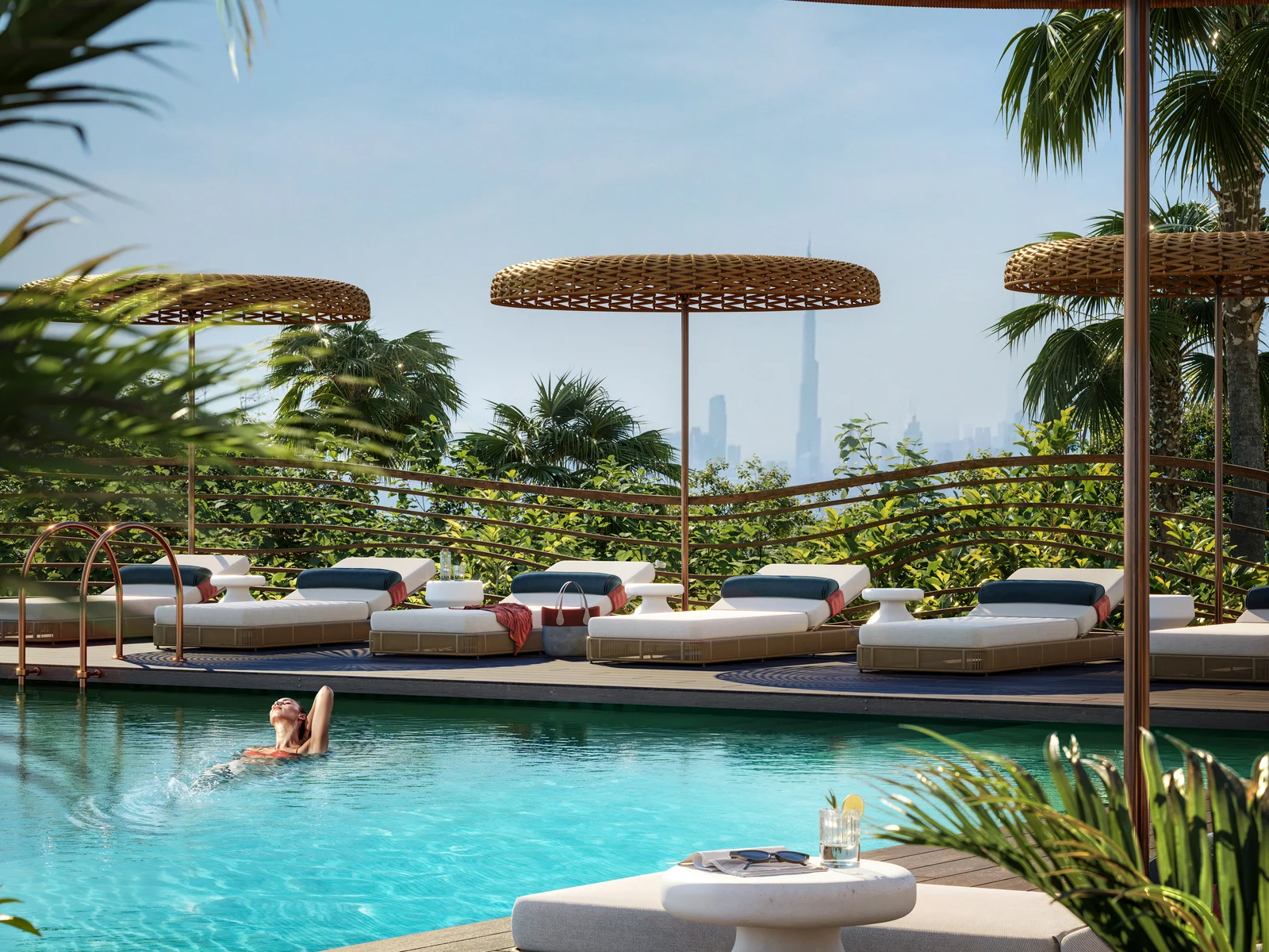 Talea, pool deck with loungers, palms and a view of the skyline